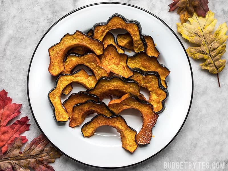 Smoky Maple Roasted Acorn Squash is an easy but elegant side dish that highlights fall produce. Easy enough for a week day, pretty enough for the holidays! Budgetbytes.com A plate of Smoky Maple Roasted Acorn Squash