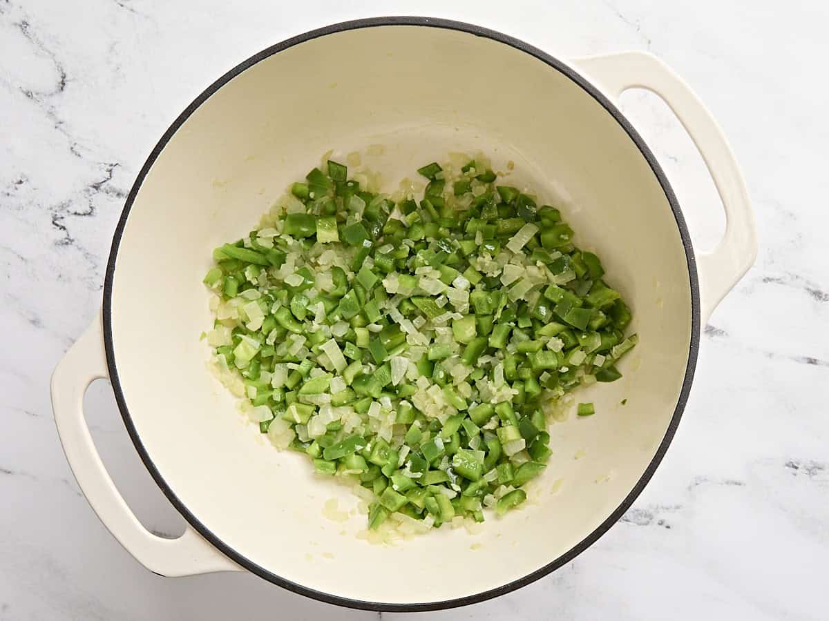 Onions, garlic, olive oil, and bell peppers in a soup pot.
