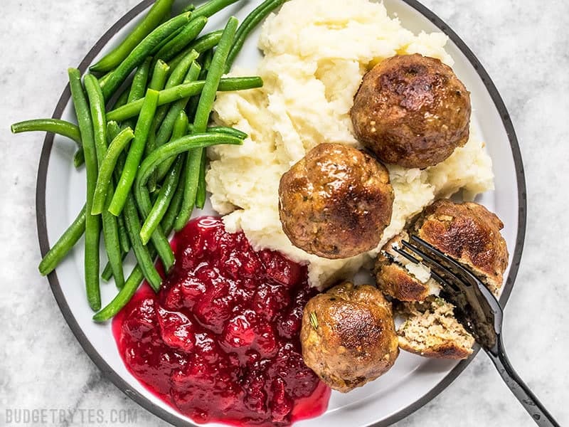 Turkey and Stuffing Meatballs make an easy and delicious addition to your Thanksgiving or Friendsgiving spread. Serve as an appetizer or main dish! Budgetbytes.com Turkey and Stuffing Meatballs served as a main dish with mashed potatoes