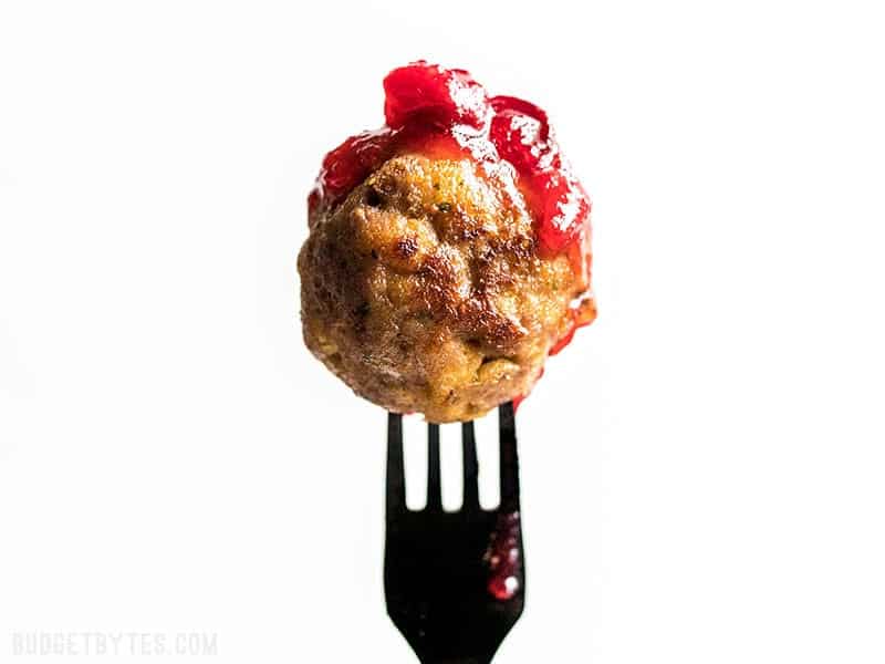 Turkey and Stuffing Meatballs make an easy and delicious addition to your Thanksgiving or Friendsgiving spread. Serve as an appetizer or main dish! Budgetbytes.com A Turkey and Stuffing Meatballs dipped in cranberry sauce.