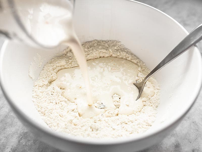 Adding the wet ingredients to the dry ingredients.