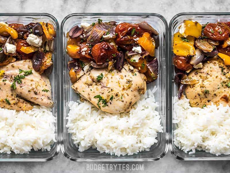 An easy homemade lemon garlic marinade transforms simple ingredients into a flavorful Sheet Pan Greek Chicken and Vegetable dinner. Perfect for weeknights! Budgetbytes.com Meal prepped Sheet Pan Greek Chicken and Vegetables