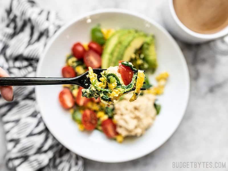 These Vegetable Breakfast Scrambles are a savory breakfast lover's dream. Fast, flavorful, full of healthy vegetables, and fully customizable. Budgetbytes.com A forkful of Vegetable Breakfast Scrambles close up