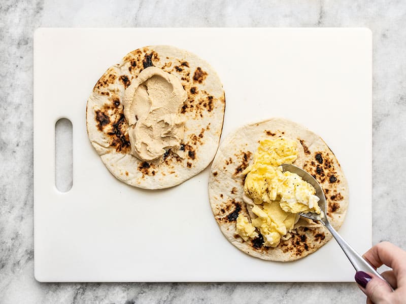 Add Hummus and Scrambled Eggs to Toasted Tortillas