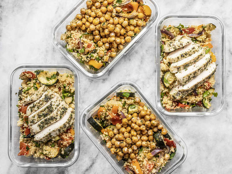 Roasted Vegetable Couscous Meal Prep is a super filling, veggie-packed meal that can be made with chicken or vegetarian with chickpeas. BudgetBytes.com Four glass meal prep containers with roasted vegetable couscous, two with sliced chicken breast, two with garlic herb chickpeas
