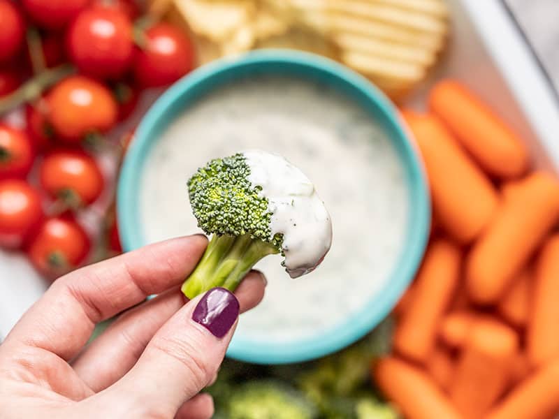 Homemade ranch dressing is creamy, tangy, and fully of savory herbs and spices. Drizzle on your favorite salad, or use as a dip for vegetables and chips! Budgetbytes.com Close up of a broccoli floret dipped in homemade ranch dressing