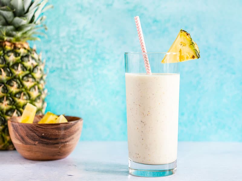 Cottage cheese is a surprisingly delicious and inexpensive source of protein in this sweet, tangy, and tropical Pineapple Protein Smoothie. Budgetbytes.com A pineapple protein smoothie in a tall glass with a paper straw, next to a whole pineapple and a small bowl of pineapple chunks