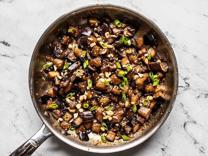 This Soy Glazed Eggplant stir fry is a super fast and easy vegetarian weeknight dinner, which also meal preps well for the week. BudgetBytes.com Soy Glazed Eggplant topped with green onion and peanuts in the skillet.