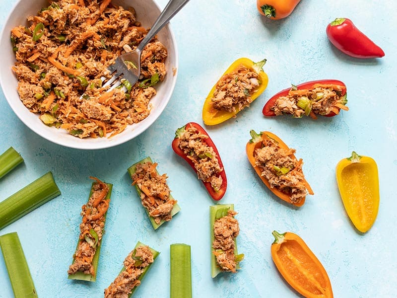 This Sweet and Spicy Tuna Salad is bold and flavorful, and has no mayonnaise! It's the perfect quick fix for summer months or your weekly meal prep. BudgetBytes.com Sweet and Spicy Tuna Salad stuffed mini peppers and celery sticks
