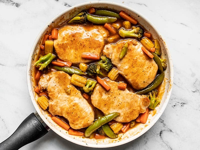 A few pantry staples are needed for these juicy Sweet and Sour Pork Chops with Vegetables, making them a quick and easy alternative to take-out. BudgetBytes.com Pork Chops added back to the skillet with the vegetables and sauce.