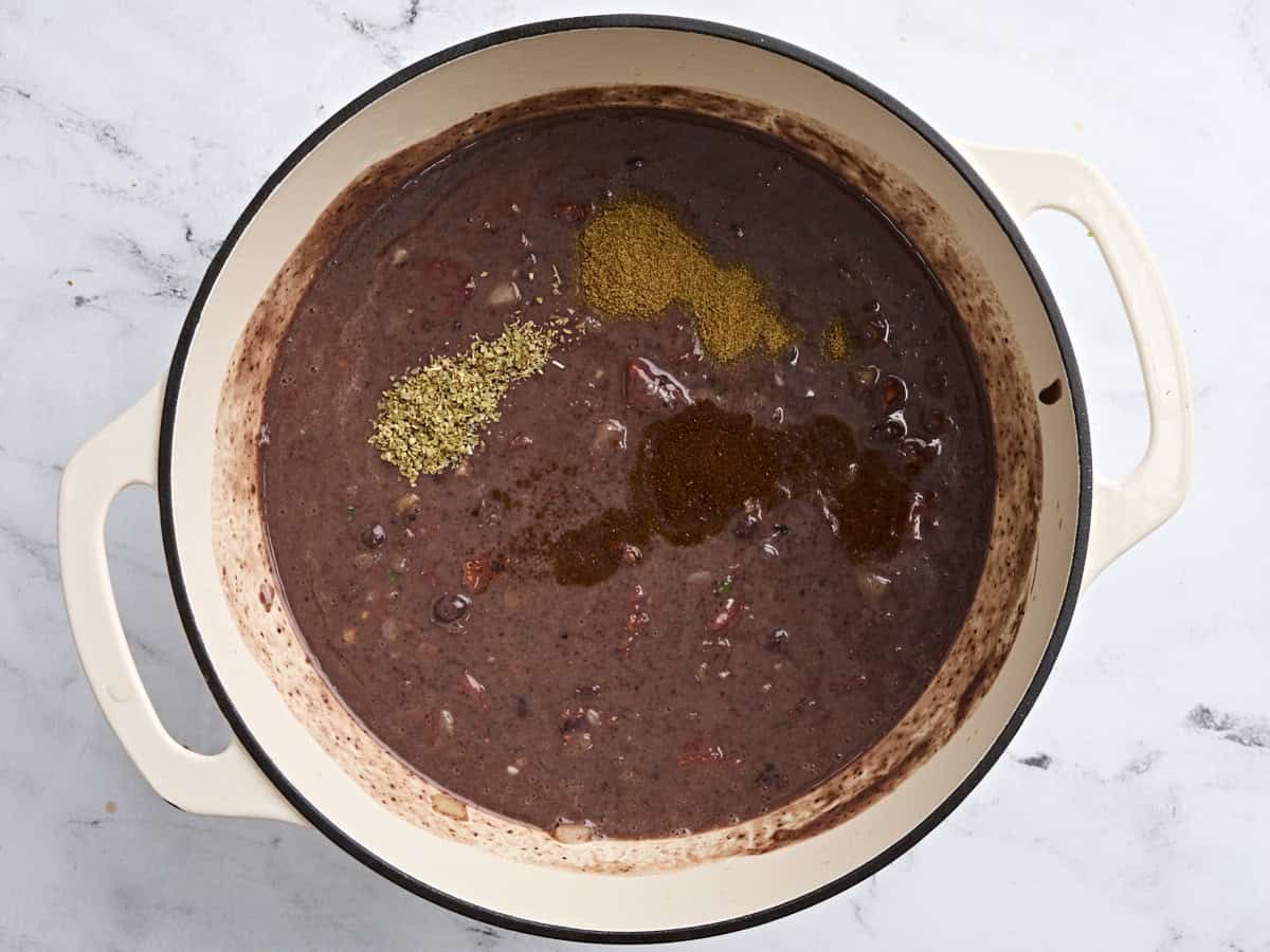 Seasonings added to a pot of homemade black bean soup.