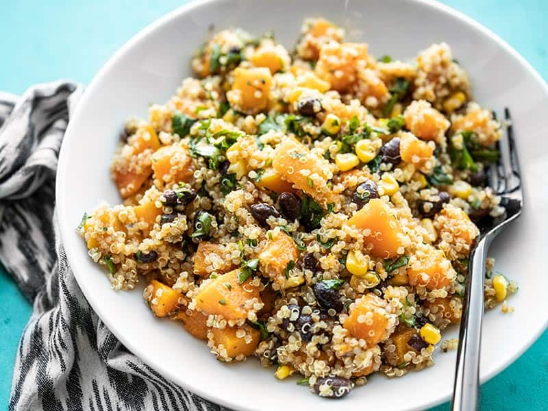 This make ahead Chipotle Butternut Squash and Quinoa Salad holds up well in your refrigerator for fast and easy lunches all week! BudgetBytes.com Side view of a bowl of Chipotle Butternut Squash and Quinoa Salad