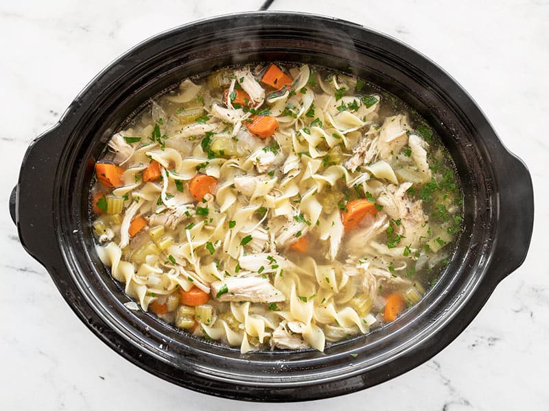 Slow cooker chicken noodle soup is an incredibly easy and soothing winter recipe that will fill you up and warm you from the inside out! BudgetBytes.com Finished Slow Cooker Chicken Noodle Soup