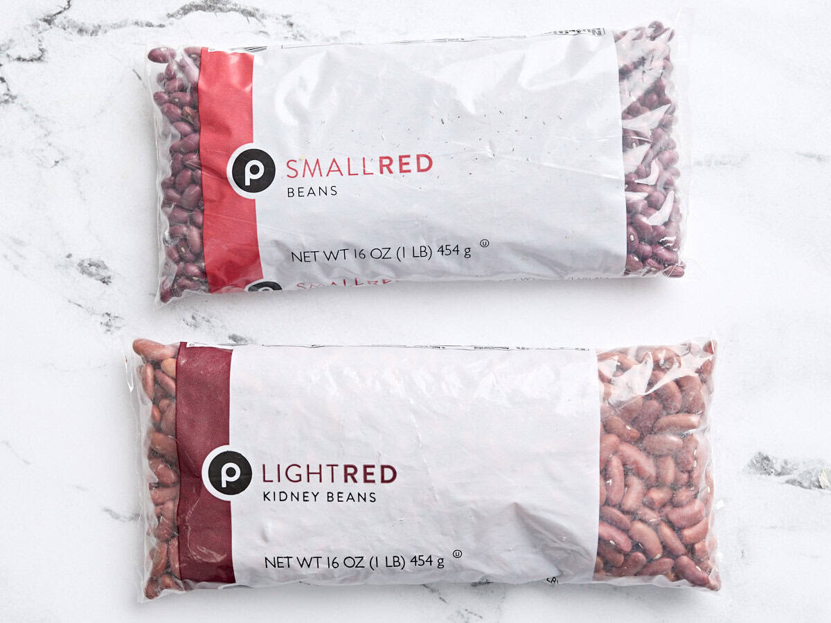 A packet of red kidney beans and a packet of small red beans.
