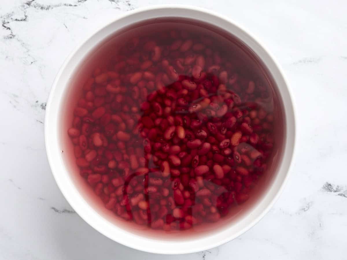 Red beans soaking in a bowl of water.