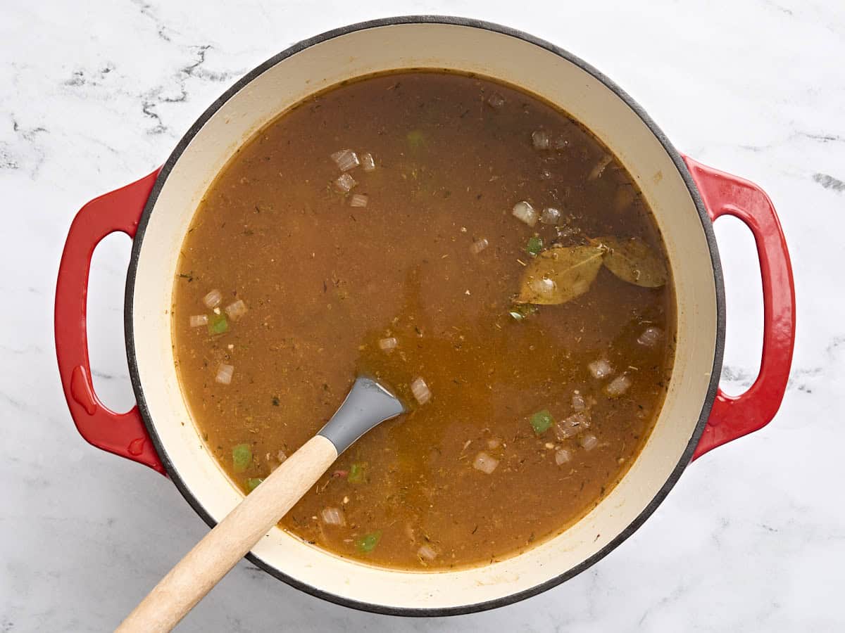 A pot of red beans, sauteed veggies, and broth before simmering.