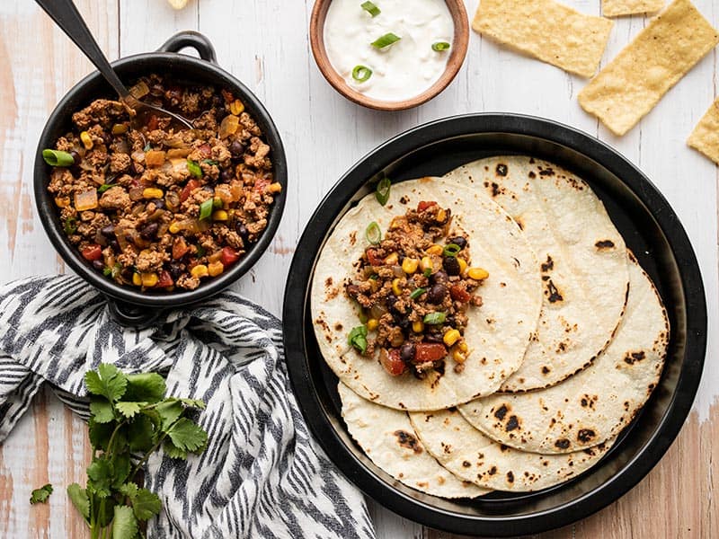 This easy and versatile Turkey Taco Skillet takes about 20 minutes to make, is freezer friendly, and can be served several different ways. BudgetBytes.com Turkey Taco Skillet served with toasted tortillas and sour cream
