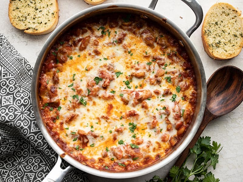 White beans make a fiber-filled swap for gnocchi in this cheesy, indulgent skillet full of white beans, mushrooms, and marinara. BudgetBytes.com Overhead view of the baked skillet full of white beans with mushrooms and marinara