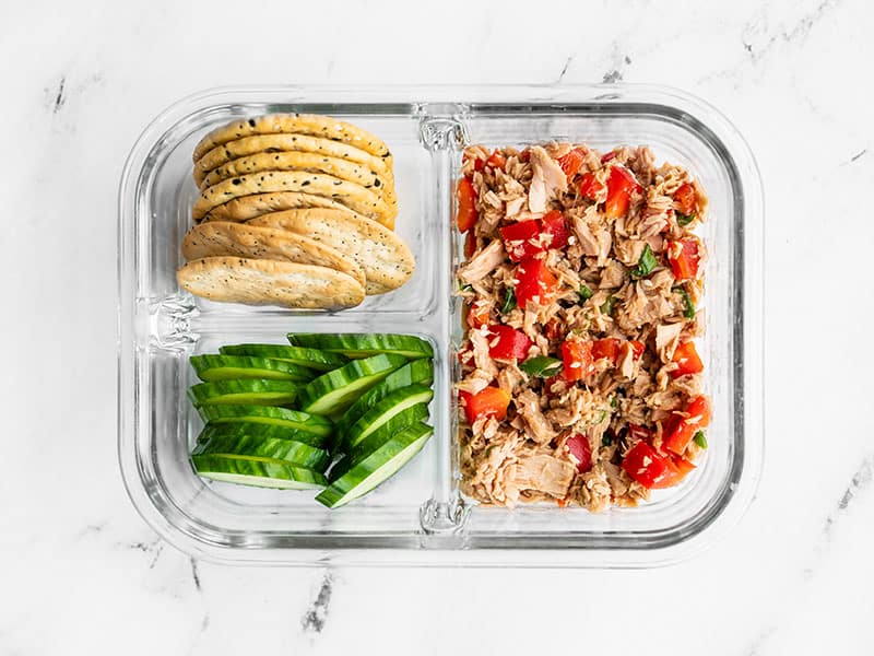 This fun spin on canned tuna is savory, sweet, and nutty. Sesame Tuna Salad is great on crackers, sliced cucumber, in lettuce wraps, or on salad greens. BudgetBytes.com Meal prep container filled with Sesame Tuna Salad, crackers, and cucumber slices