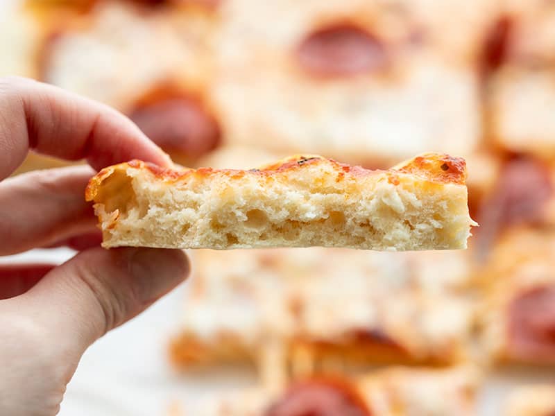 This quick and easy no yeast pizza dough only takes 15 minutes to make and is a great substitute for the classic when ingredients are in short supply. BudgetBytes.com Inside look at a piece of no yeast pizza crust