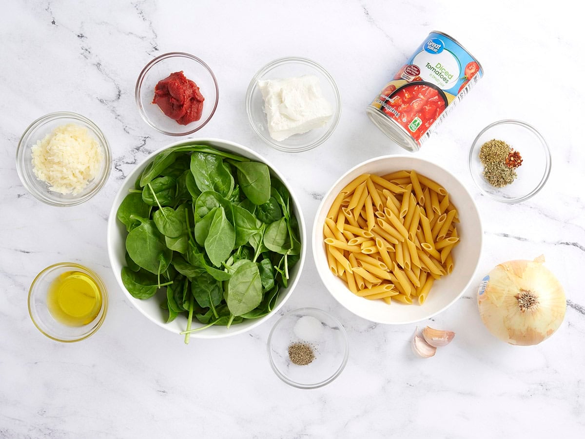 The ingredients to make creamy tomato spinach pasta.