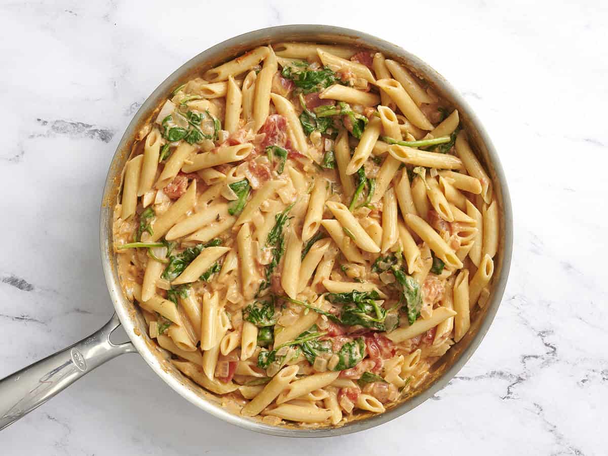 Easier than a box meal, this creamy tomato and spinach pasta is also more flavorful and delicious. 100% real ingredients. Perfect for busy weeknights! Budetbytes.com A skillet of creamy tomato and spinach pasta.