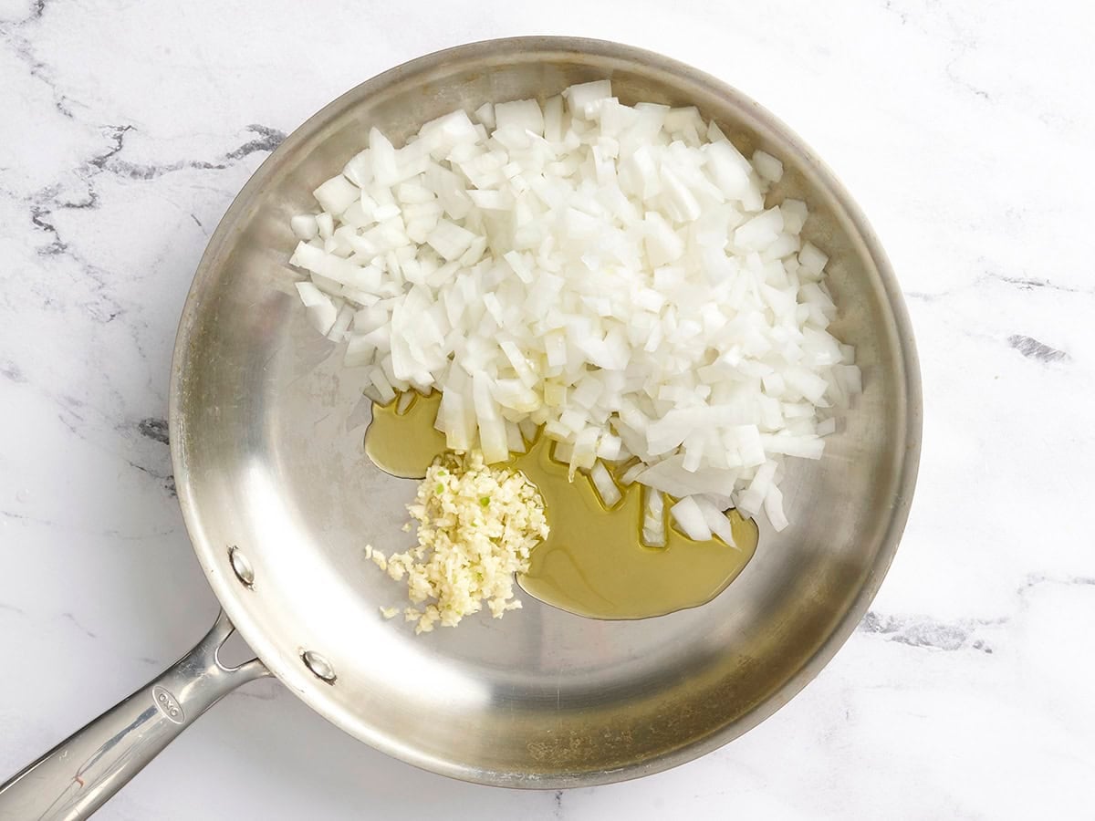 Diced onion and minced garlic with oil in a skillet.