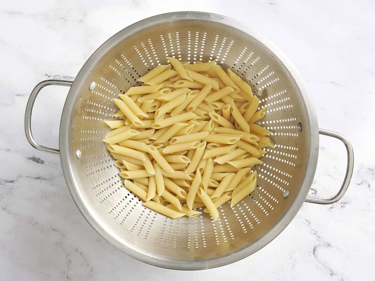 Cooked pasta in a colander.