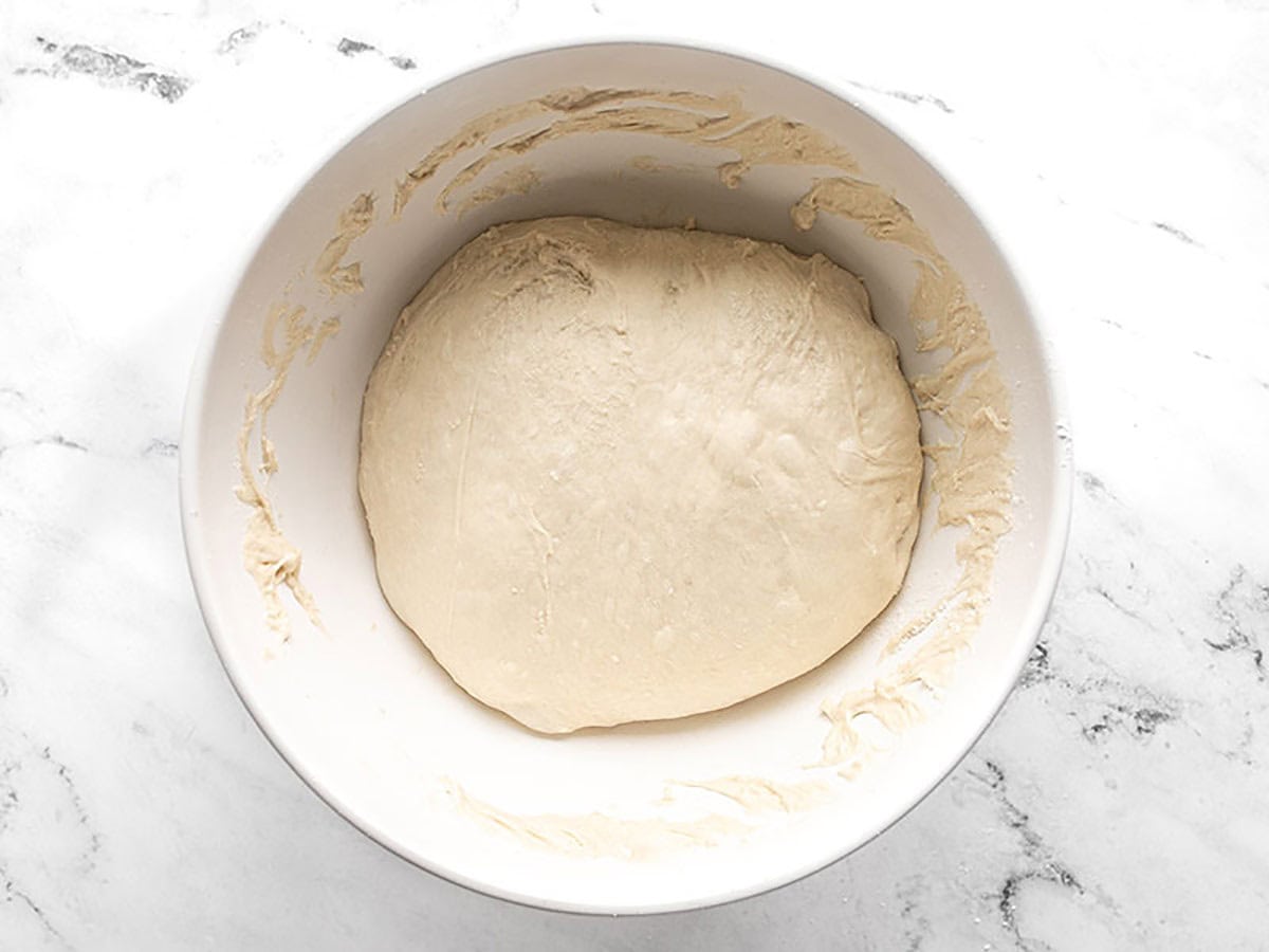 Smooth folded focaccia dough in the mixing bowl.