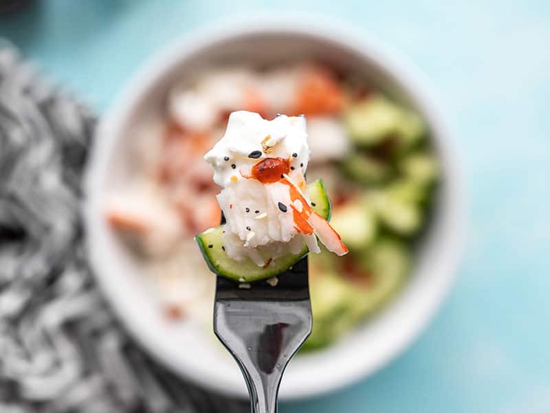 This Cottage Cheese Crab Bowl is the perfect light, fresh, and filling lunch for summer. It also meal preps well, so pack a few to take to work for lunch! Budetbytes.com Close up of a bite of Cottage Cheese Crab Bowl on a fork