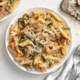 Overhead view of creamy spinach pasta on a plate.