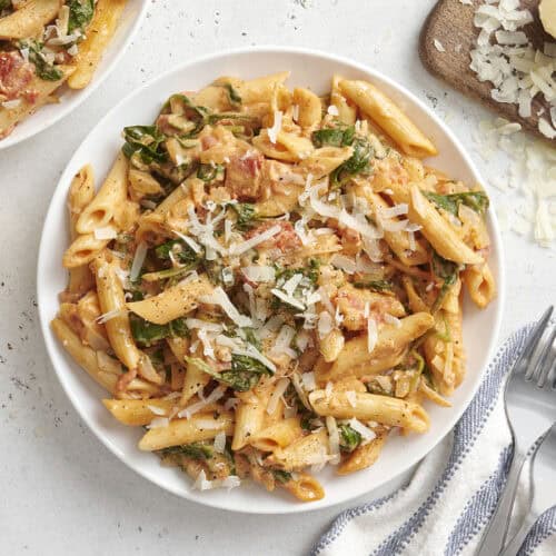 Overhead view of creamy spinach pasta on a plate.