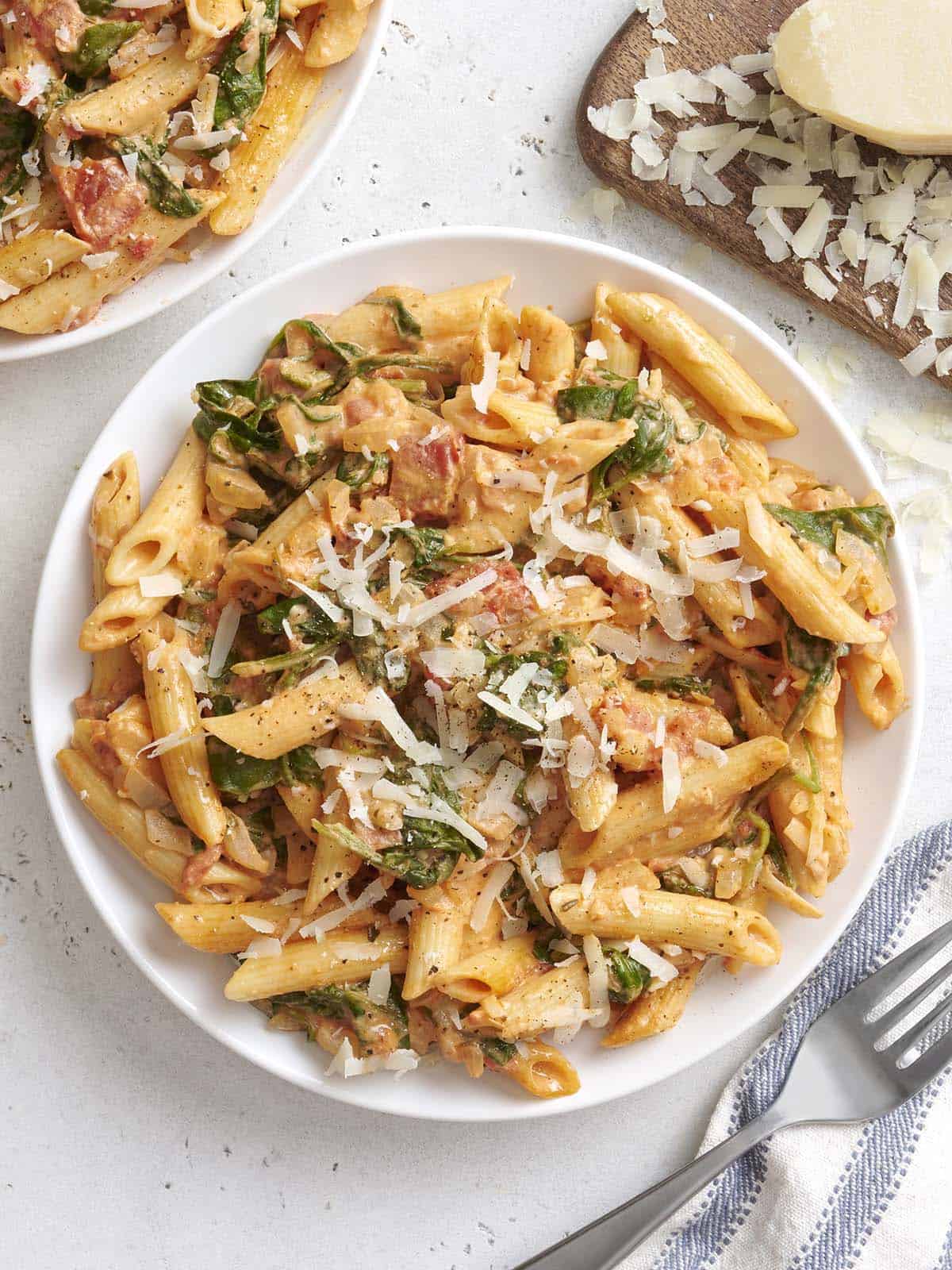 Easier than a box meal, this creamy tomato and spinach pasta is also more flavorful and delicious. 100% real ingredients. Perfect for busy weeknights! Budetbytes.com Overhead view of a plate of creamy tomato and spinach pasta.