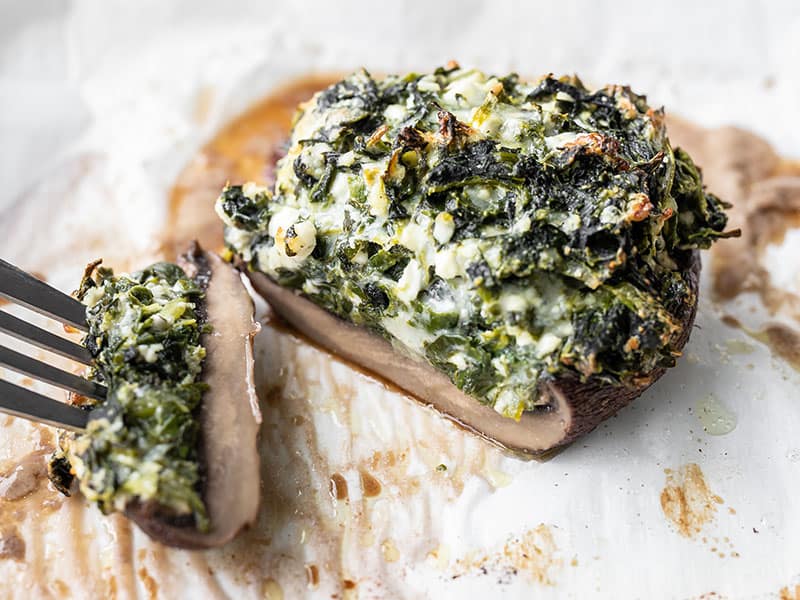 These Spinach Stuffed Portobellos combine a flavorful mixture of three cheeses and spinach with hearty portobello mushrooms for an easy meat-free main dish. Budetbytes.com A spinach stuffed portobello mushroom cut open so you can see the inside
