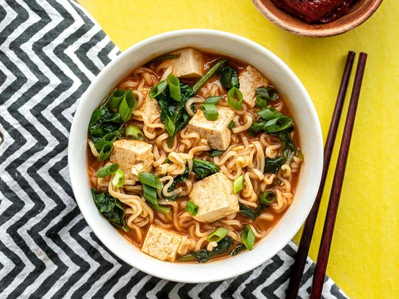 Spicy gochujang gives this instant ramen extra oomph! Gochujang Ramen with Tofu is a quick and easy way to satisfy that noodle craving. Budgetbytes.com One bowl of gochujang ramen with tofu, chopsticks on the side
