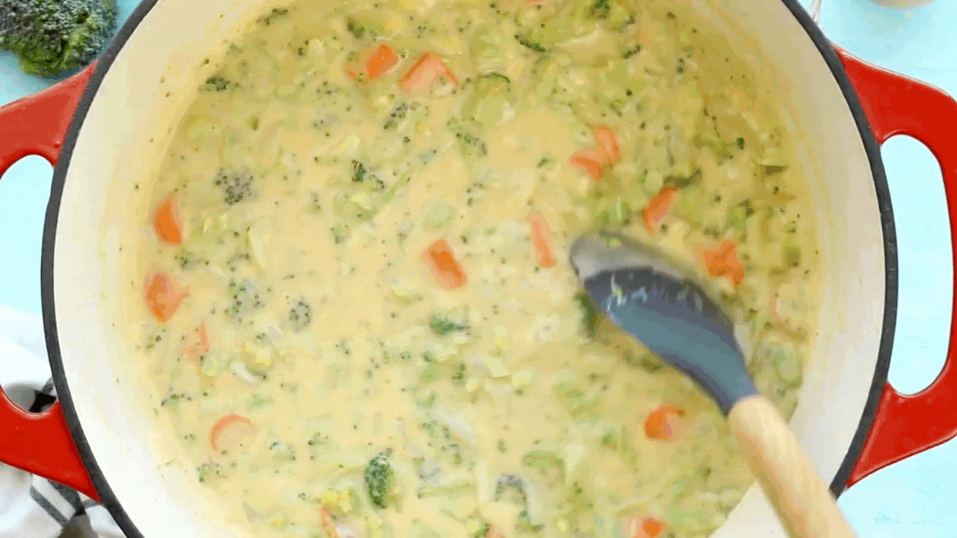 A video GIF showing a ladle taking some broccoli cheddar soup from a pot.