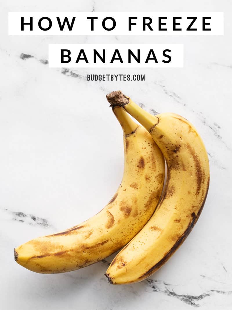 A simple, step by step tutorial on how to freeze bananas for user later in banana bread, smoothies, muffins, and more. Recipe ideas included! Budgetbytes.com Two brown bananas on a marble surface with title text at the top