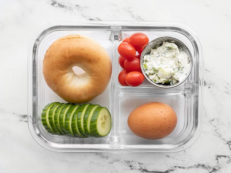 This Bagel Lunch Box is an easy and affordable grab and go breakfast or lunch idea, perfect for work or school. Budgetbytes.com One bagel lunch box in a glass meal prep container