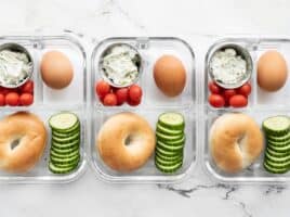 Three bagel lunch boxes lined up in a row