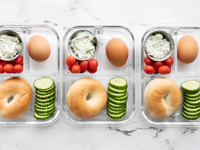 This Bagel Lunch Box is an easy and affordable grab and go breakfast or lunch idea, perfect for work or school. Budgetbytes.com Three bagel lunch boxes lined up in a row