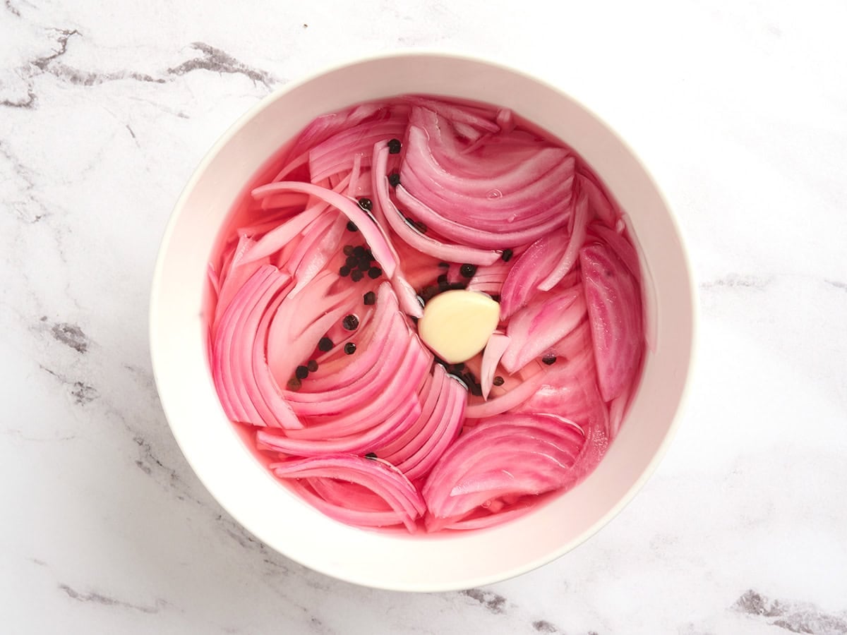 A bowl of pickled red onions.