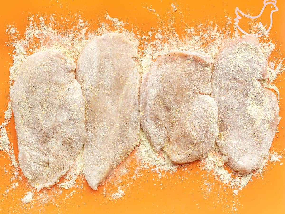 Coated chicken breasts on the cutting board