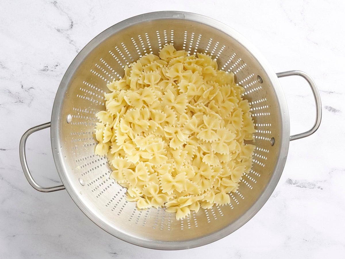 Cooked pasta in a colander.