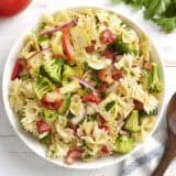 Overhead view of a bowl of summer vegetable pasta salad.