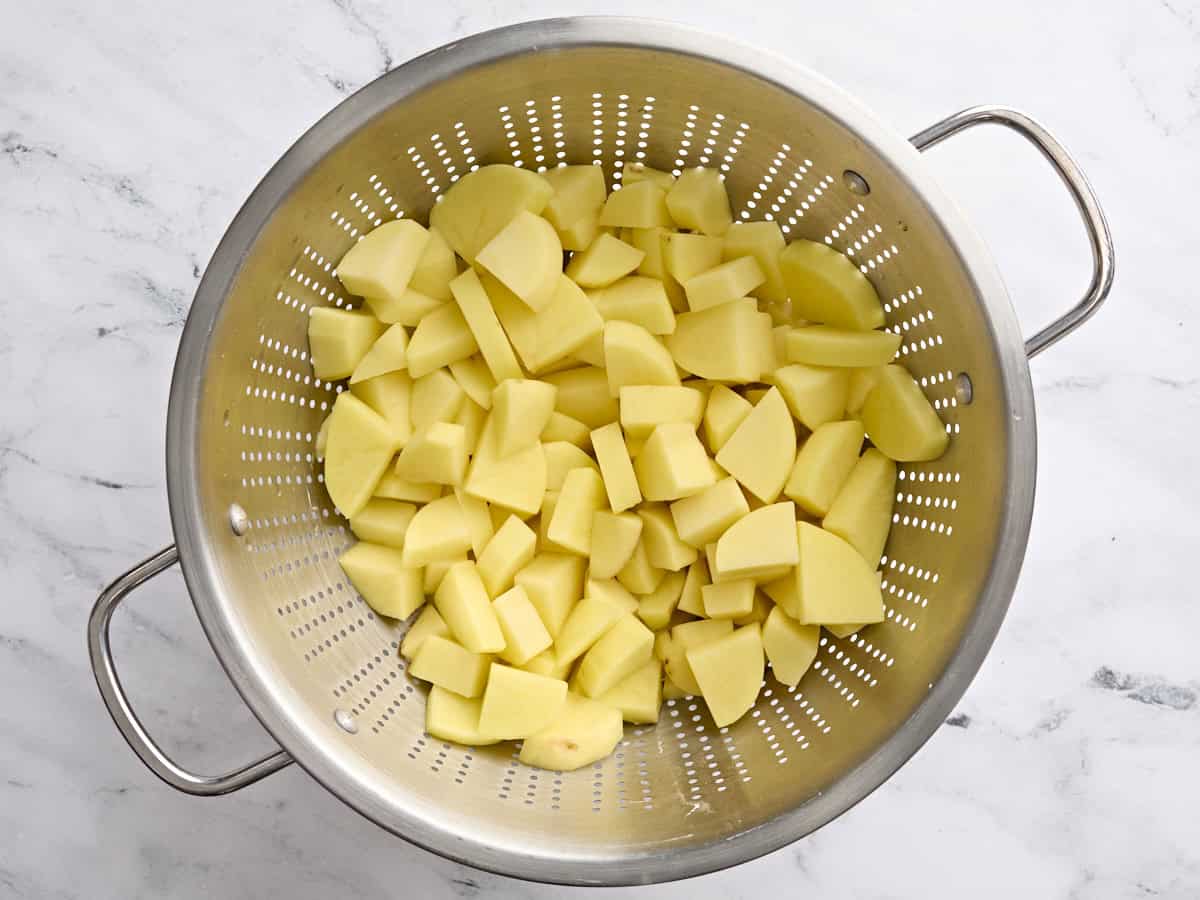 Cubed potatoes in a colander.