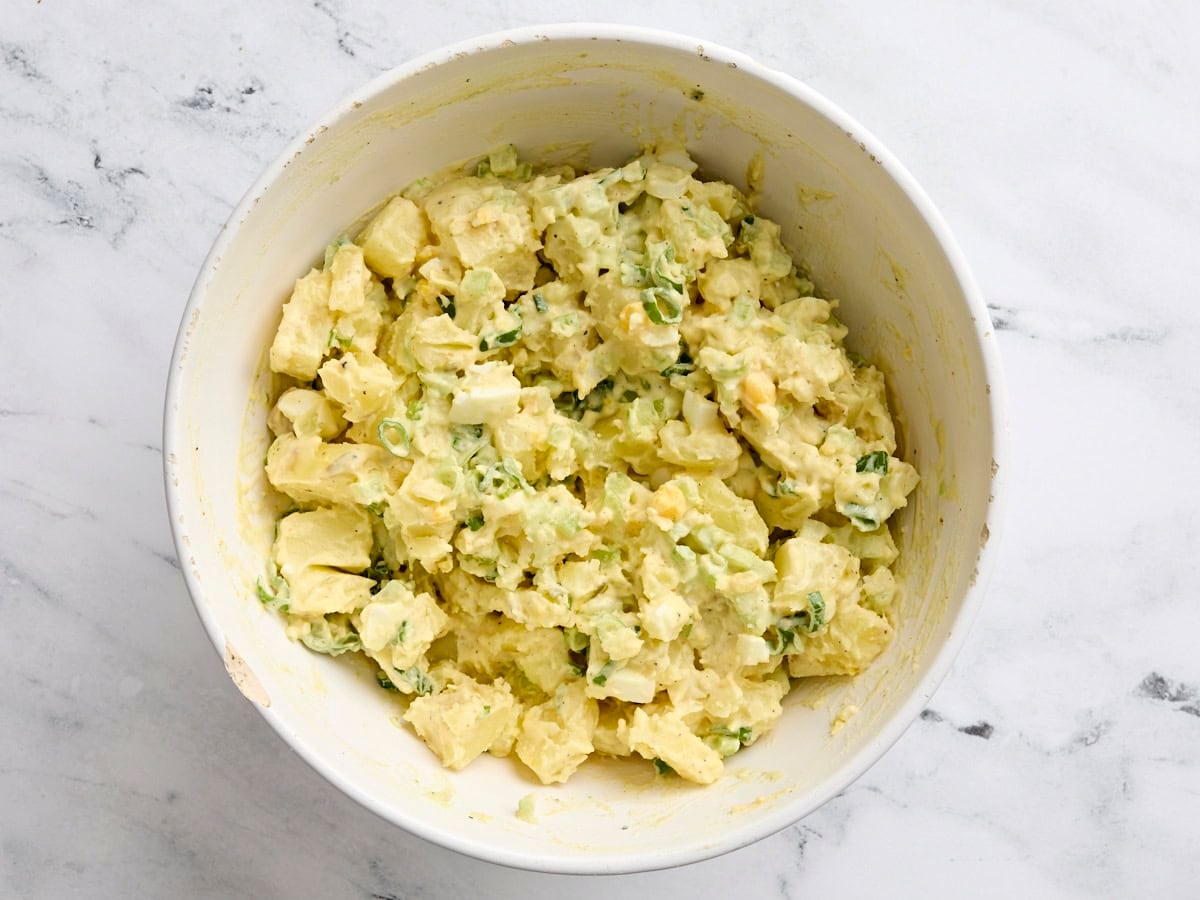 Finished classic Southern style potato salad in a mixing bowl.