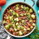 overhead view of beef and cauliflower taco skillet with vegetables on the sides