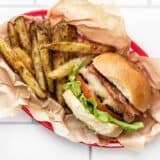 a bacon ranch turkey burger in a basket with fries