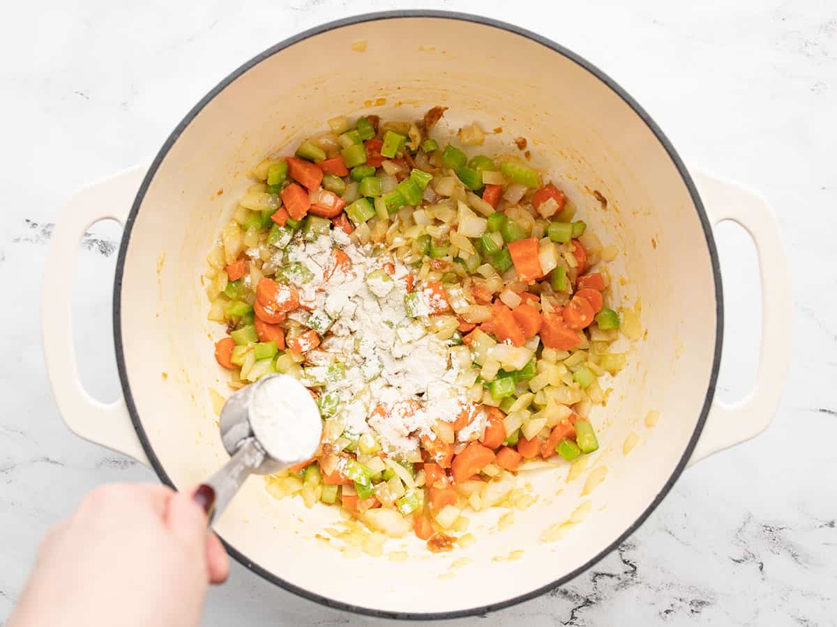 More flour being added to the pot.