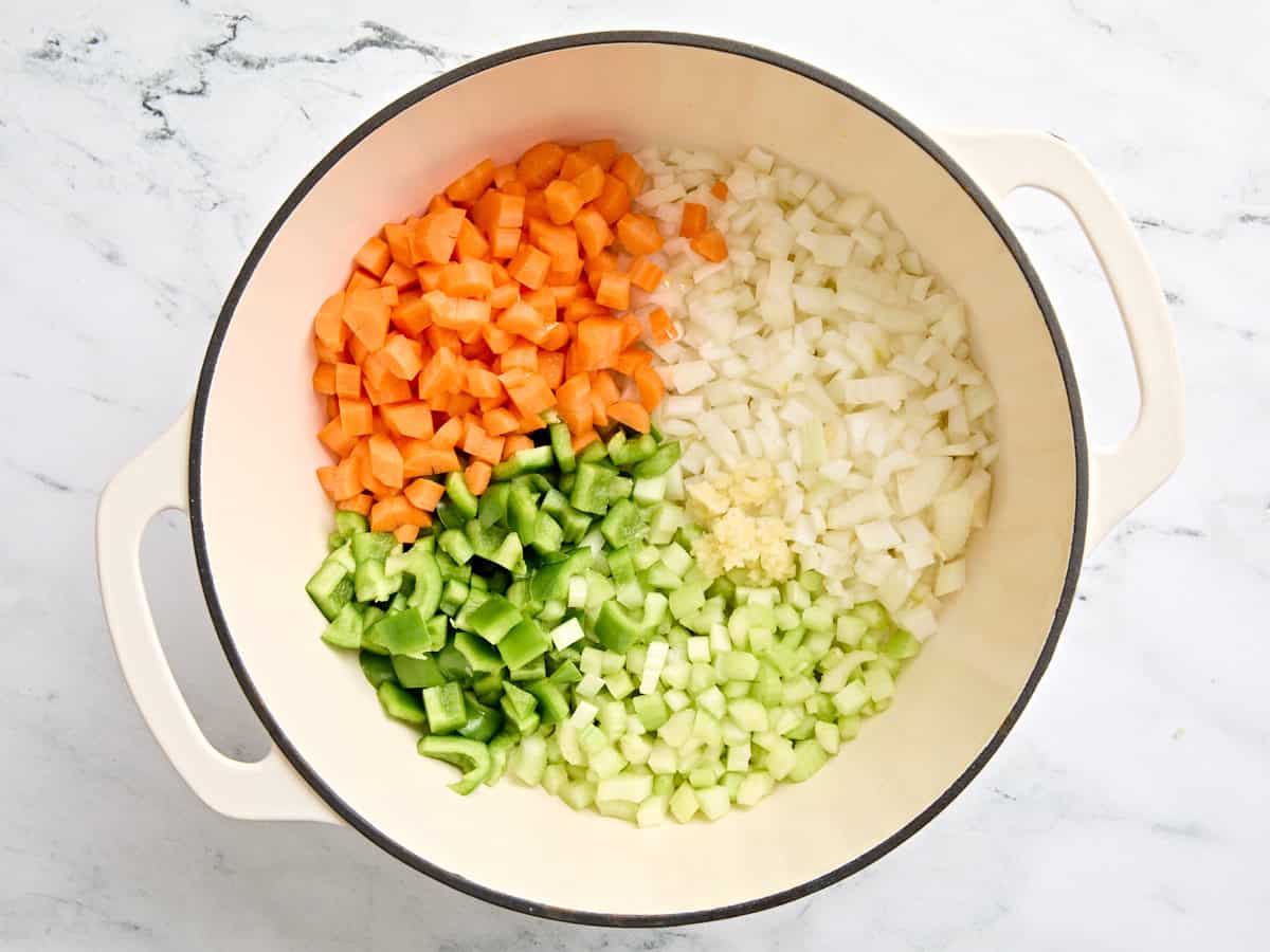 Chopped carrots, bell pepper, onion, and minced garlic in a soup pot.